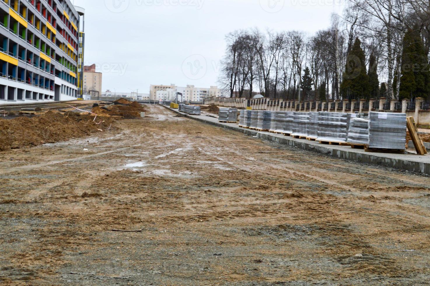 Industrial construction and repair of roads and sidewalks with laying of asphalt and paving slabs using modern building materials and technologies photo