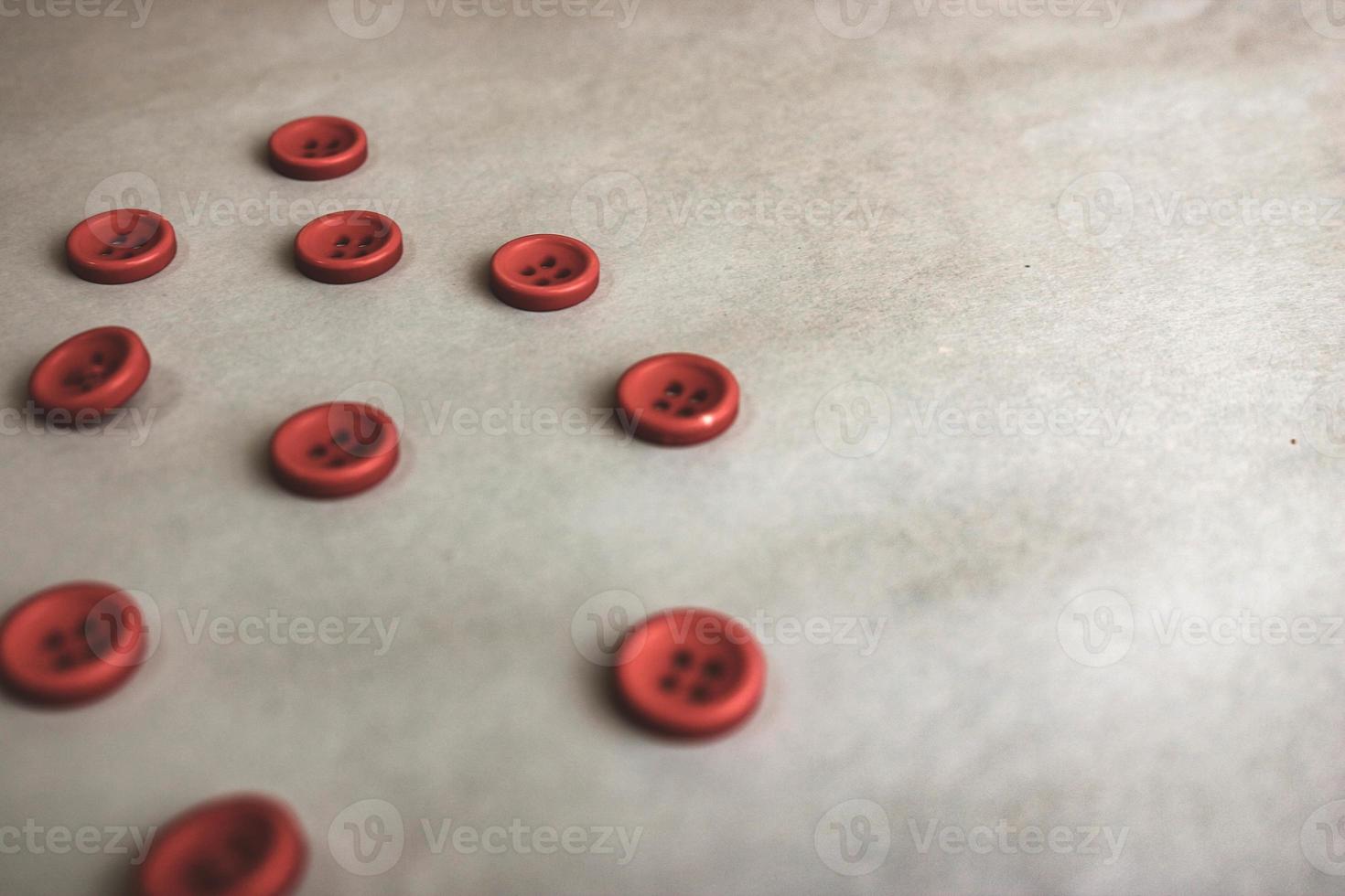 Beautiful texture with many round red buttons for sewing, needlework. Copy space. Flat lay. Blue background photo