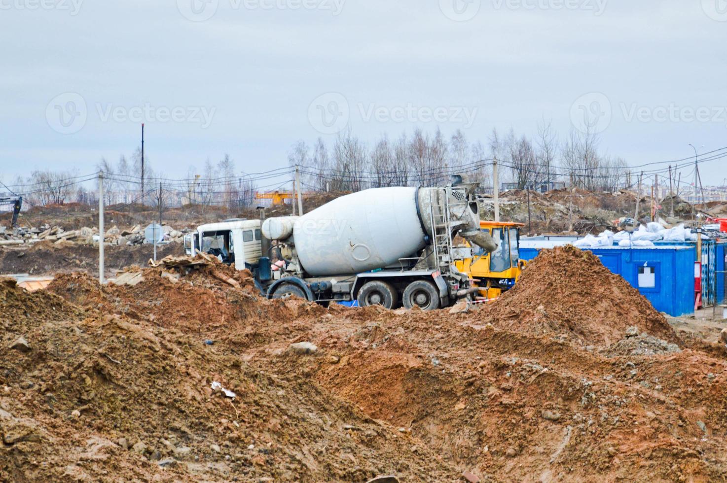 Large powerful truck concrete mixer at an industrial large construction site photo