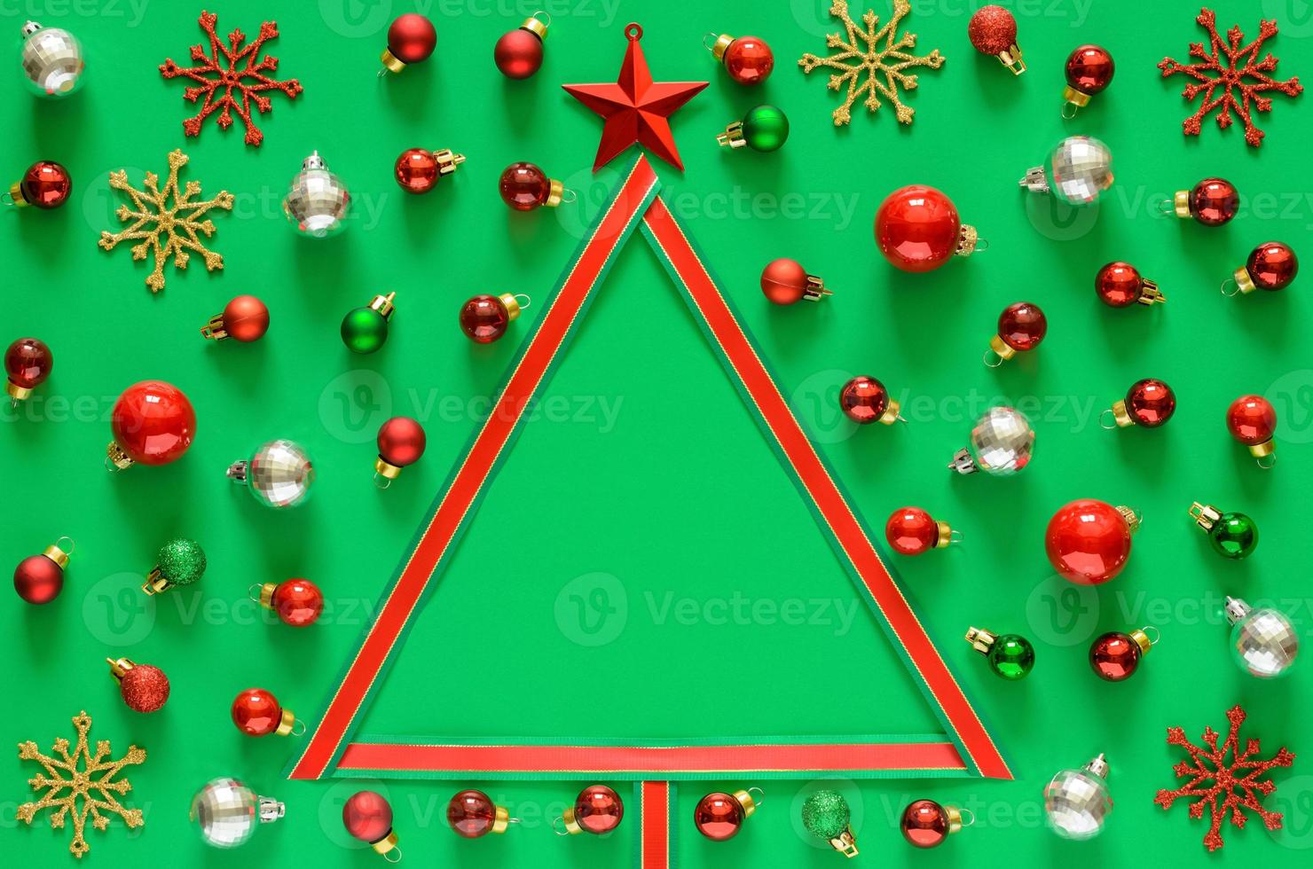 Colorful baubles ornament and ribbon set and Christmas tree on green background with space for text. Christmas holiday concept. photo
