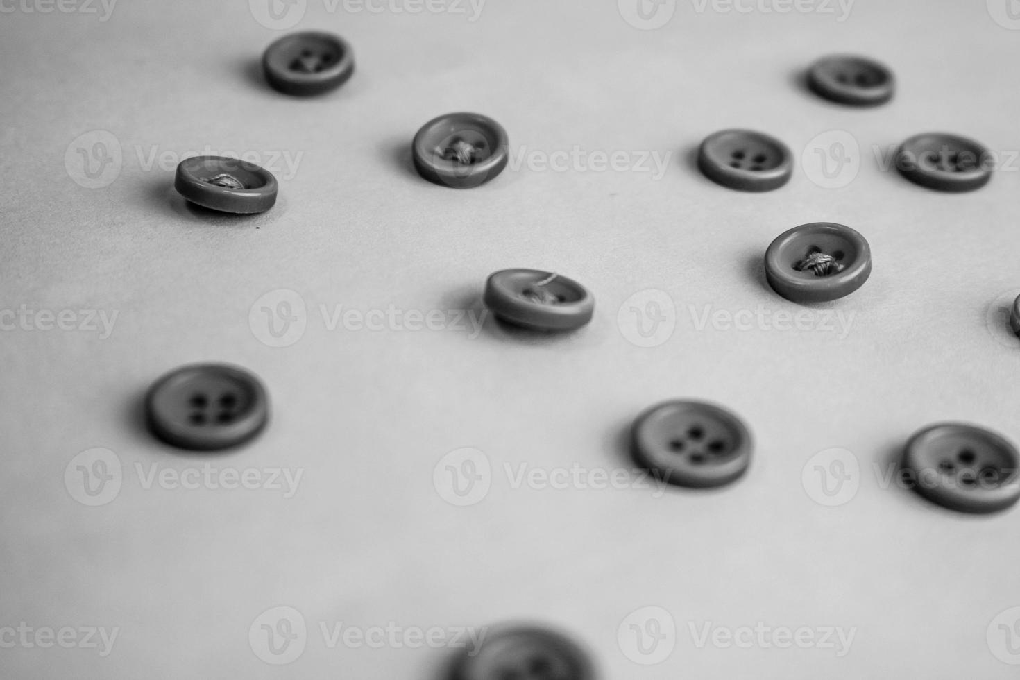 Beautiful black and white texture with a lot of round buttons for sewing, needlework. Copy space. Flat lay. the background photo