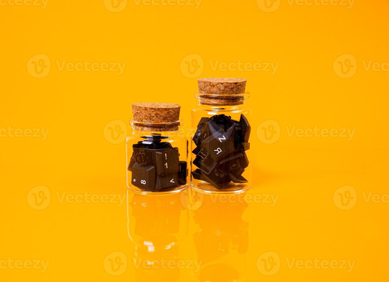keyboard button in glass in jar in bucket on orange background photo