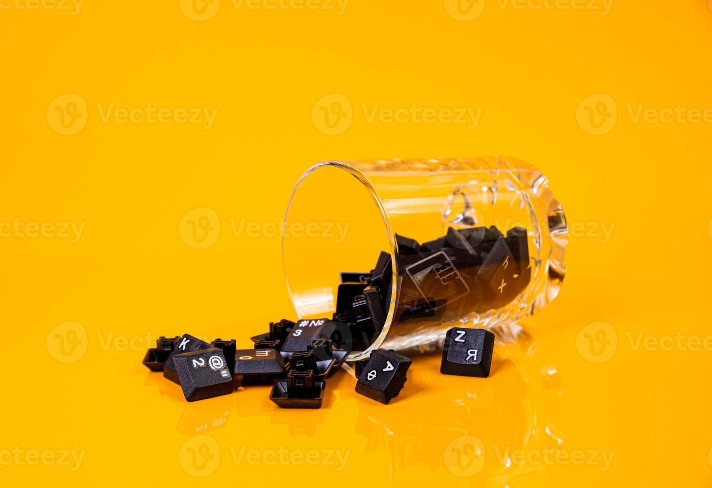 keyboard button in glass in jar in bucket on orange background photo