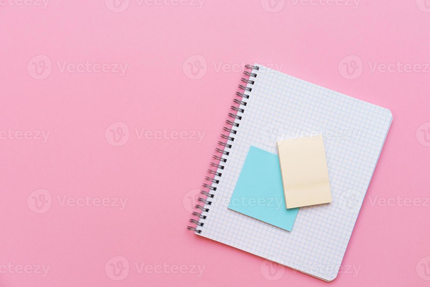 An open spiral notepad with stickers lying on top. Stationery photo