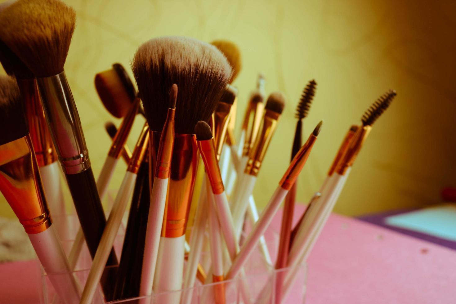 A set of beautiful different soft brushes for make-up from natural nap for the guidance of beauty and the application of a tonal foundation in a stand photo