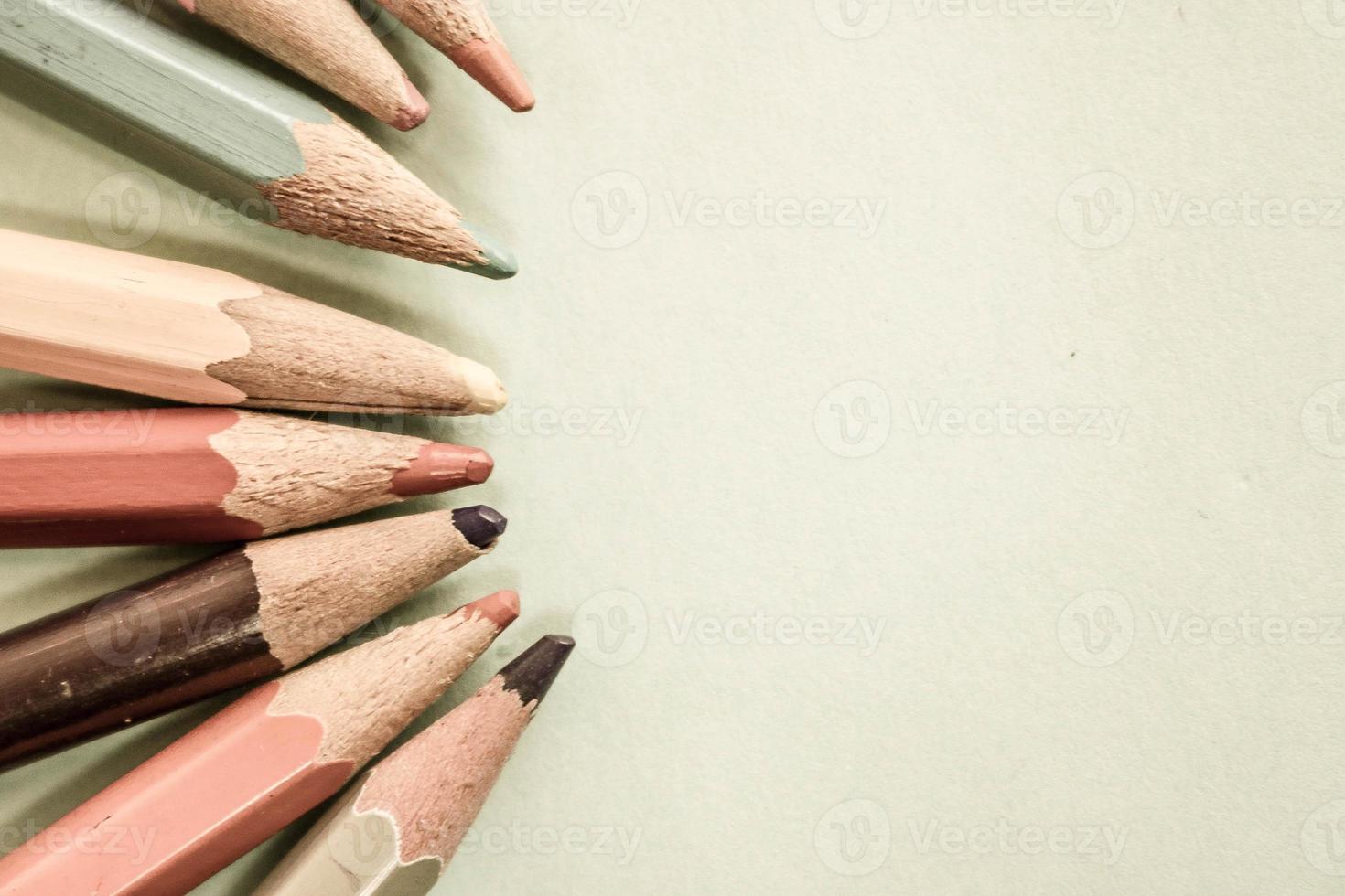 Beautiful bright colored wooden colored sharpening pencils for drawing. Flat lay and copy space on blue background photo