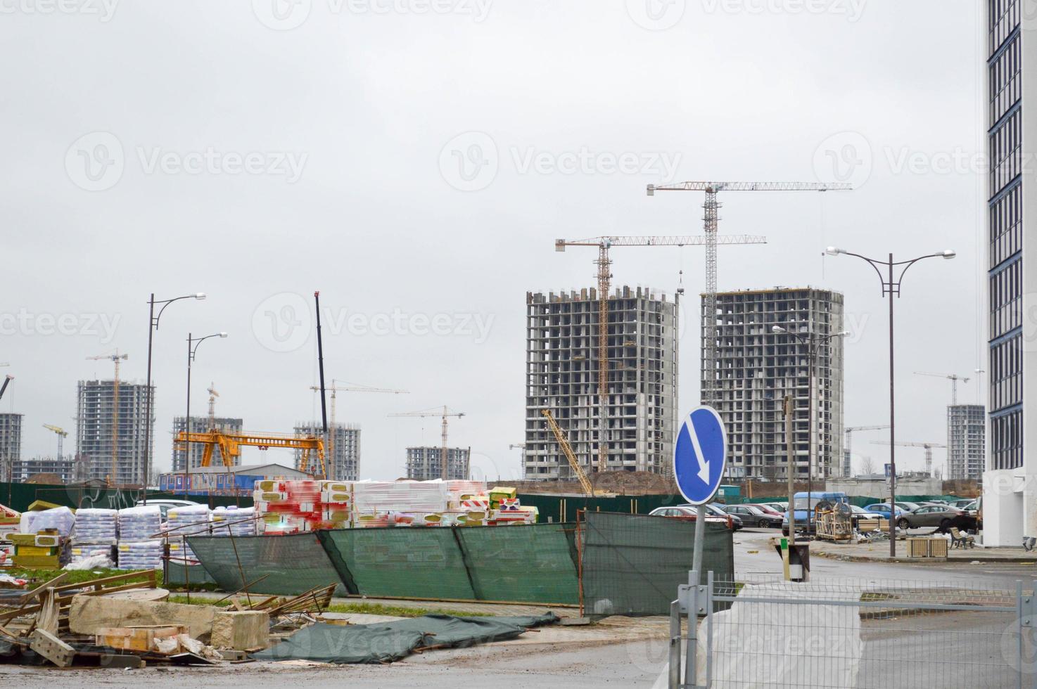 Construction of a large multi-storey comfortable concrete cement modern new monolithic-frame multi-storey building with windows, walls and balconies photo