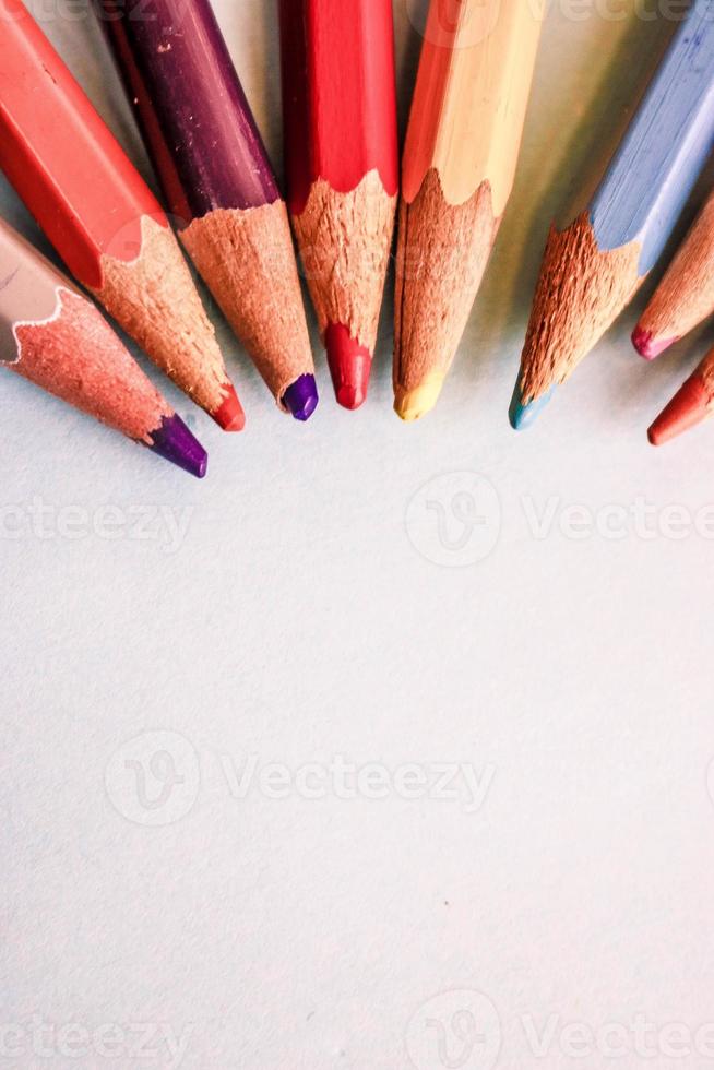 Beautiful bright colored wooden colored sharpening pencils for drawing. Flat lay and copy space on blue background photo