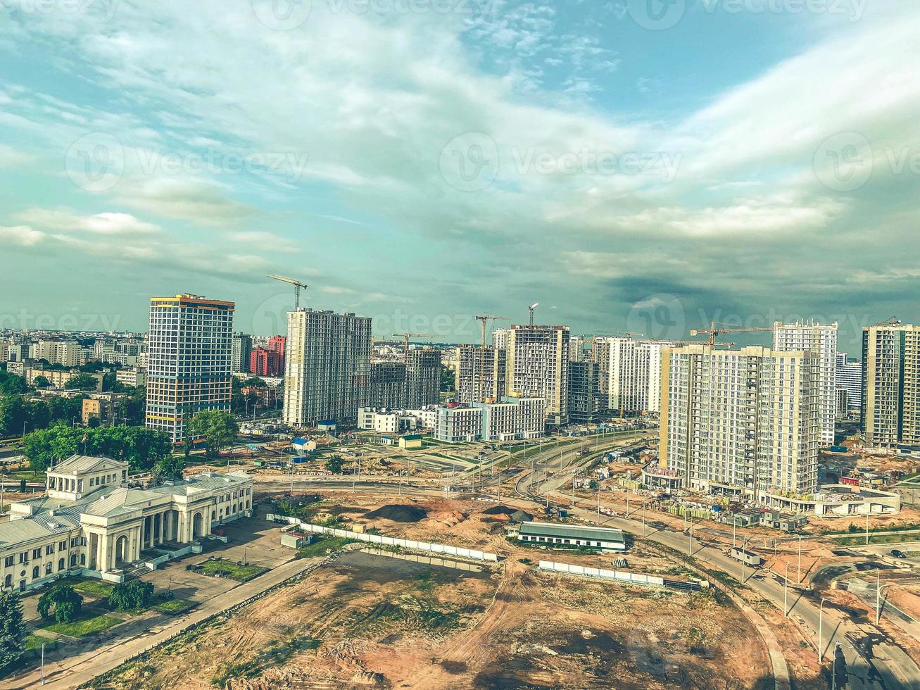 construction of multi-storey buildings in the city center. tall houses made of concrete blocks and slabs. a huge city on the sand grew out of concrete photo