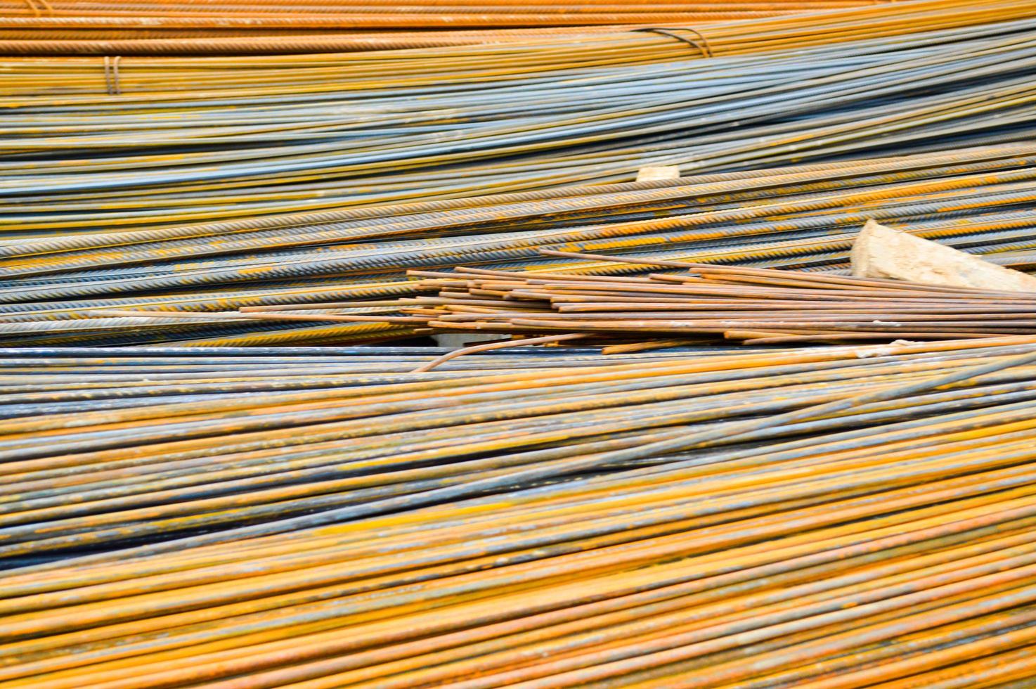 Iron metal rusty yellow bars of industrial building reinforcement from corrugated reinforcement for the construction of buildings made of reinforced concrete. Texture, background photo