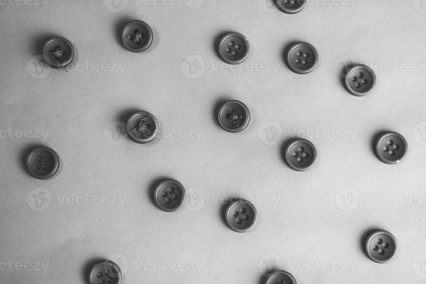 Beautiful black and white texture with a lot of round buttons for sewing, needlework. Copy space. Flat lay. the background photo