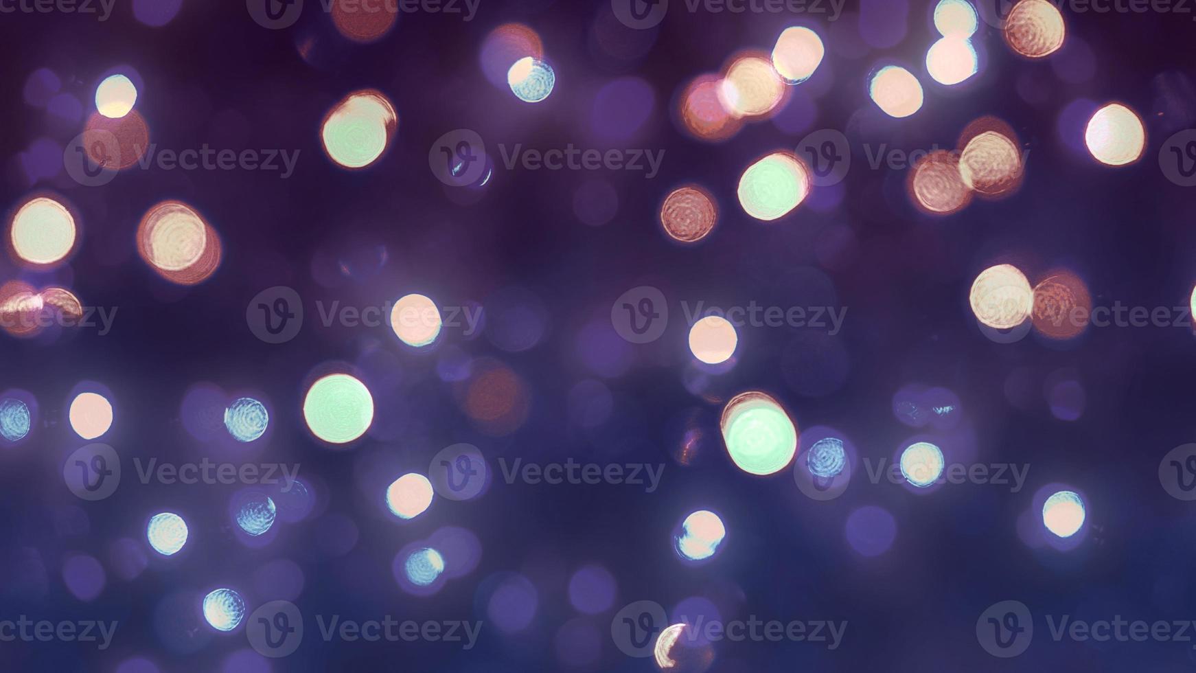 Composite image of bokeh style Christmas lights against a purple background. photo