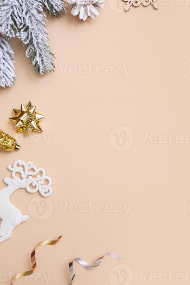 Christmas flat lay composition with gifts, cones, pine on beige background top view. Copy space. photo