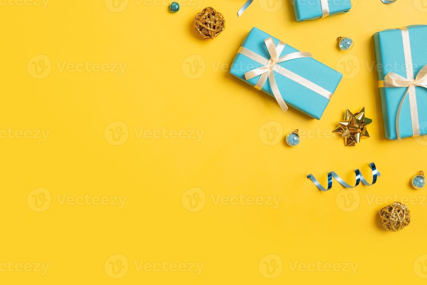 Christmas background with blue gift boxes on colored backdrop top view. Copy space photo