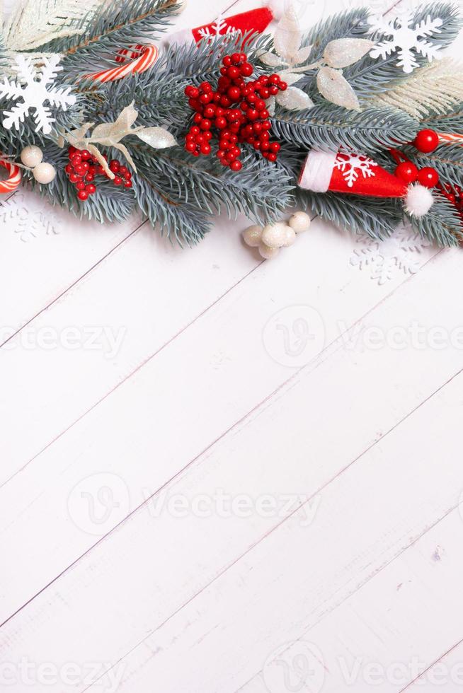 Christmas vertical background made from pine tree, snowflakes and festive decorations top view. Christmas flat lay photo