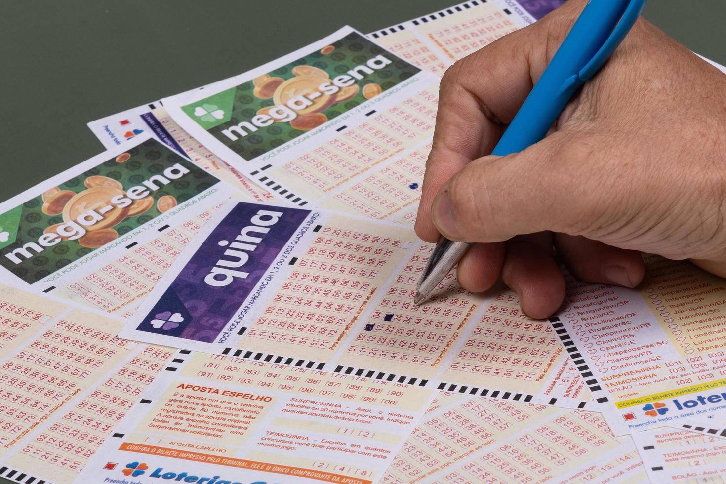 Rio, Brazil, July 20, 2022, person filling out Caixa Economica Federal lottery card, the only official betting method in Brazil photo