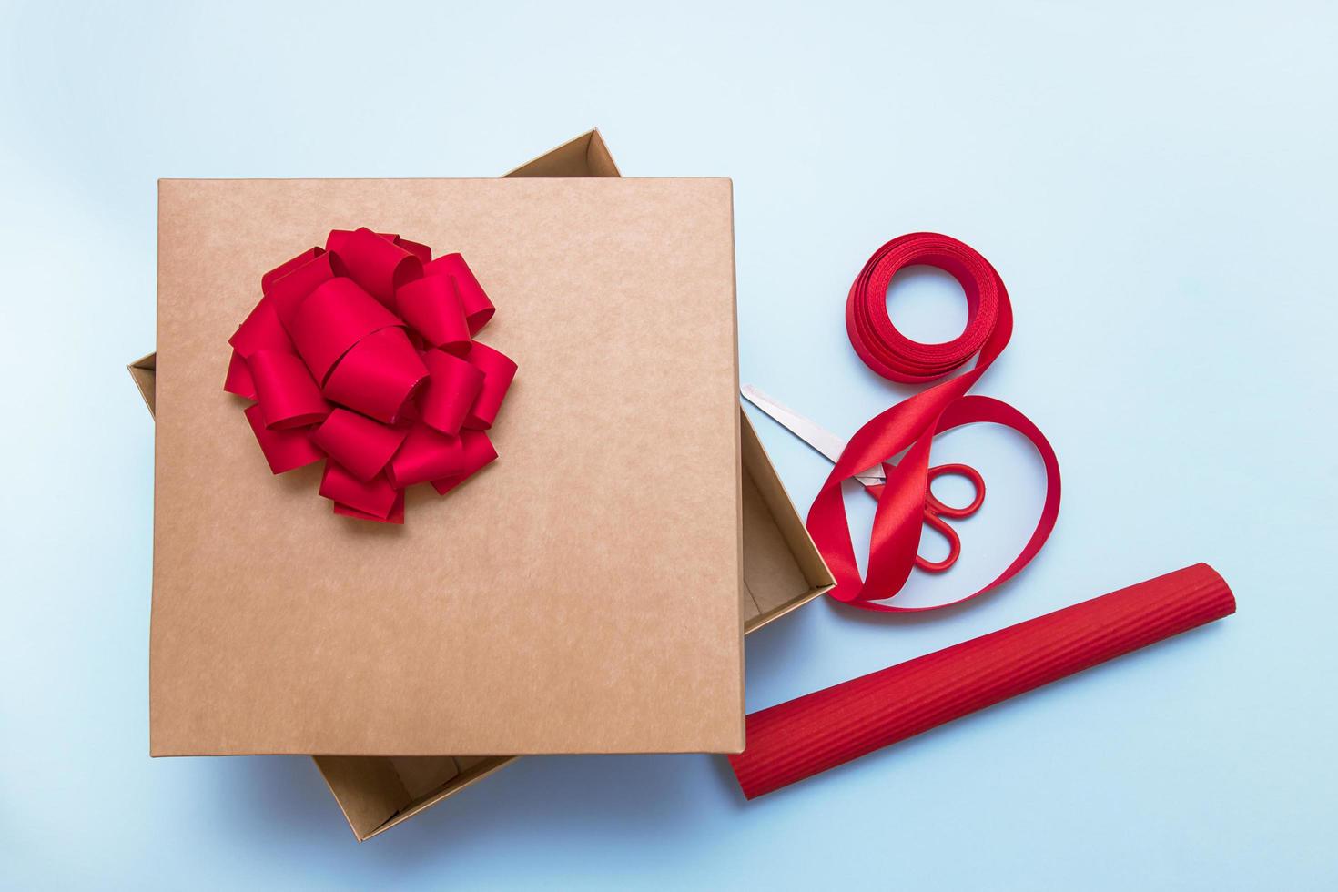 open gift box, scissors, ribbon, wrapping paper, bows to decorate it photo