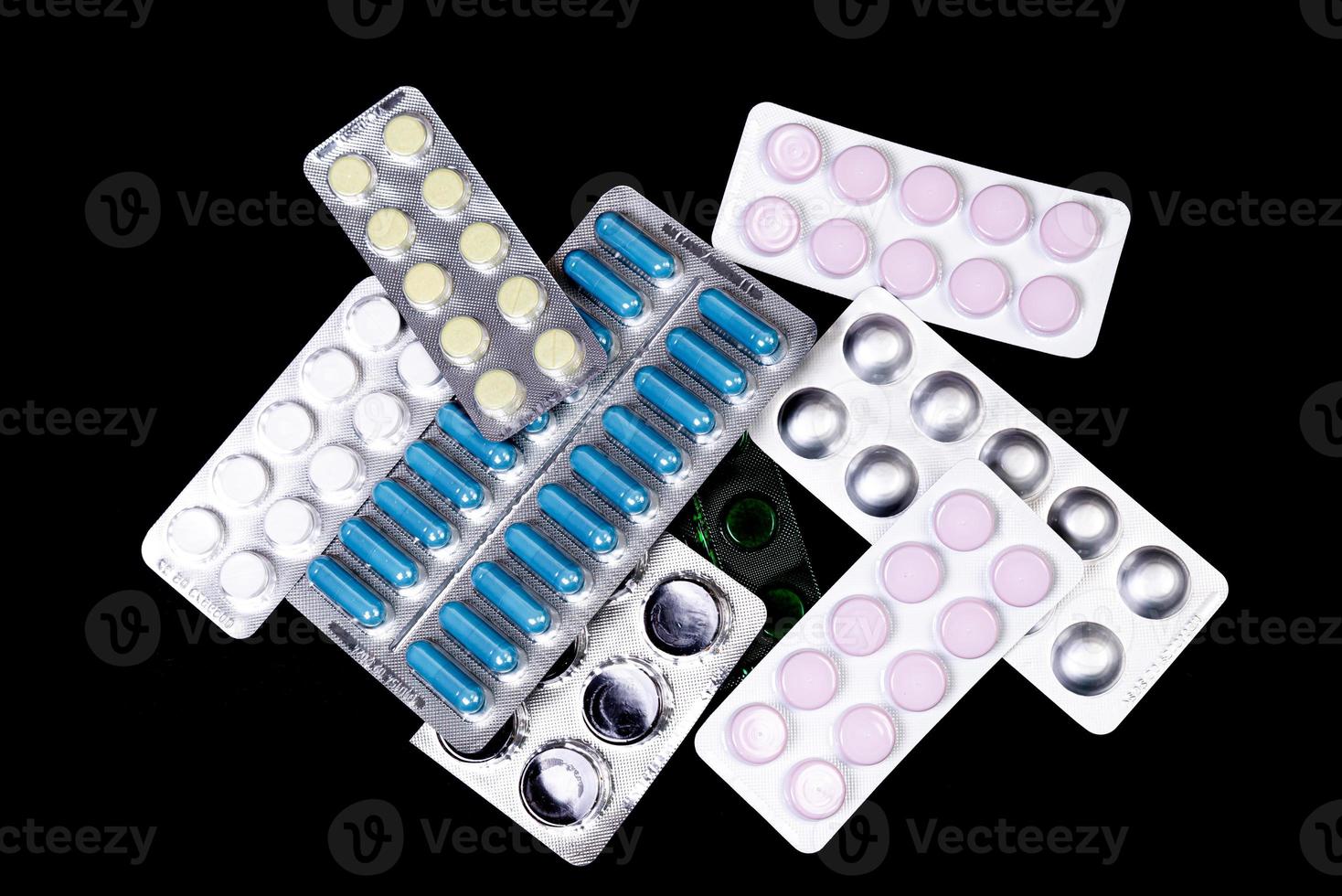 Capsules in a blister on a black background photo