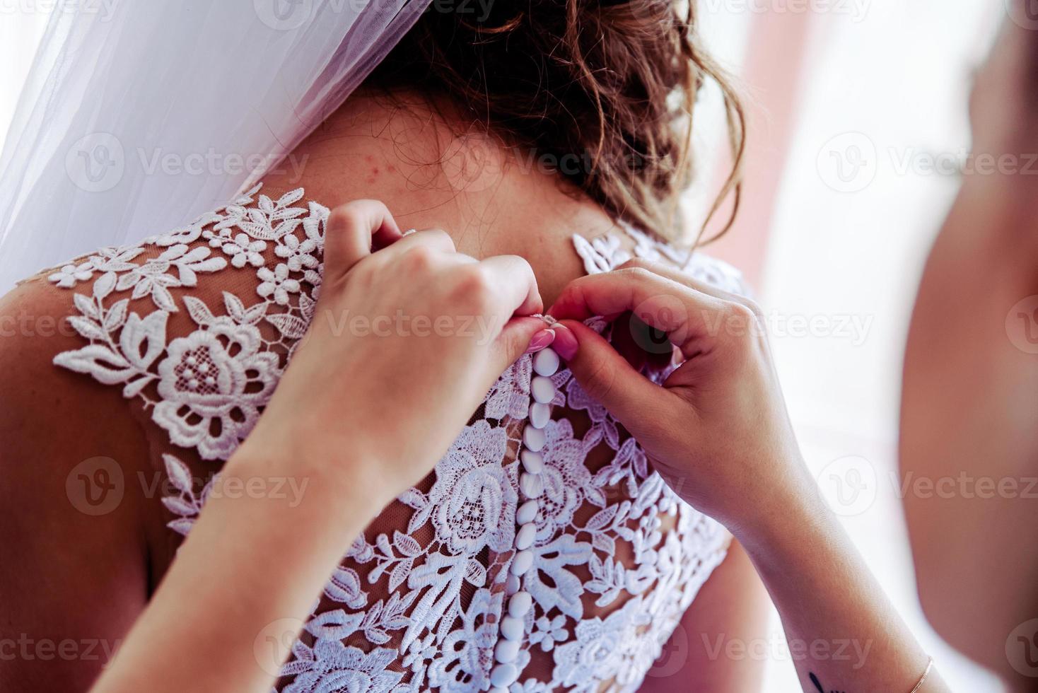 Bridal morning, bride wears dress. photo