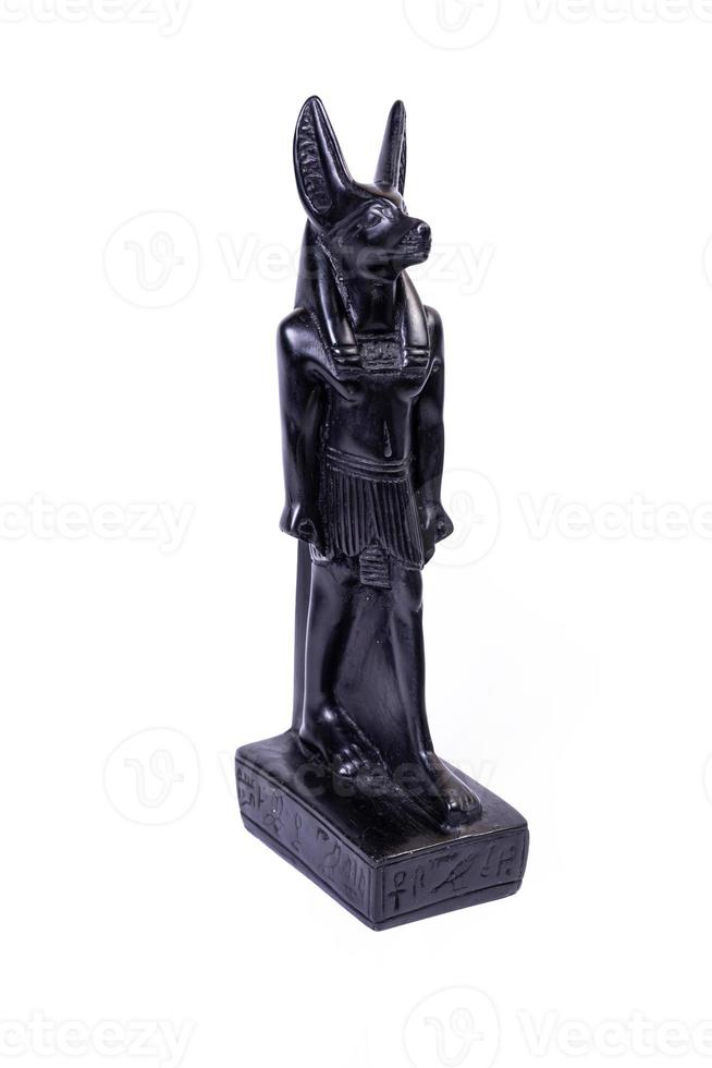 stone figurine of egyptian god Anubis with jackal head isolated on white background. photo
