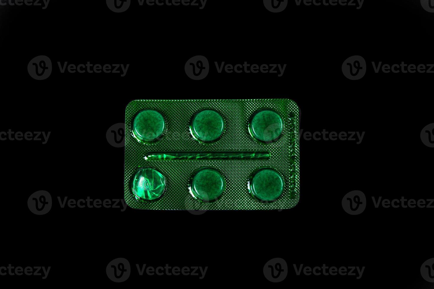 Capsules in a blister on a black background photo