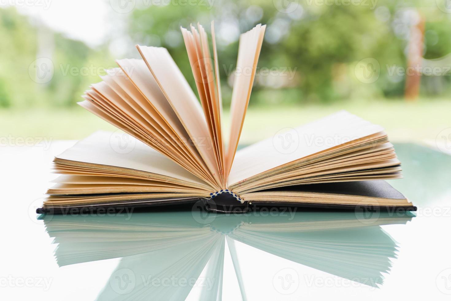 Open book on table photo