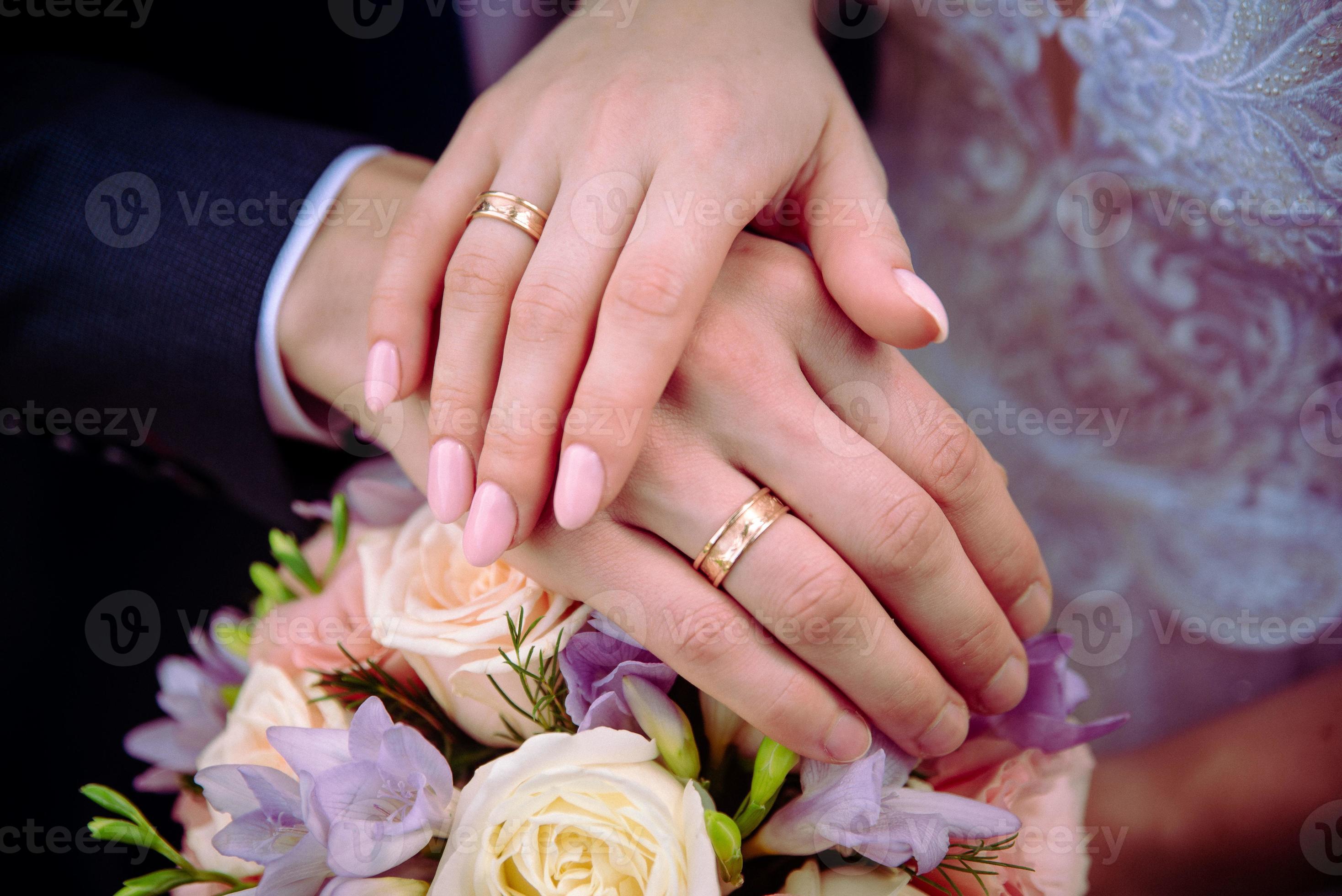 A couple holding hands with engagement ring and blue clothes - a Royalty  Free Stock Photo from Photocase