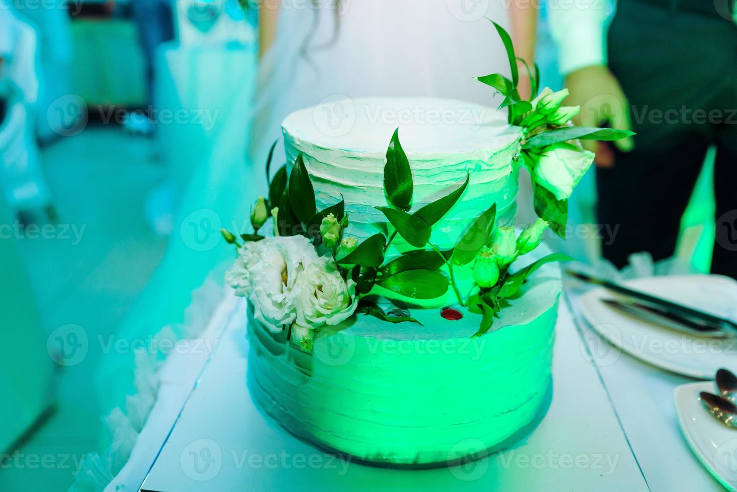 White wedding cake decorated by flowers fruits photo