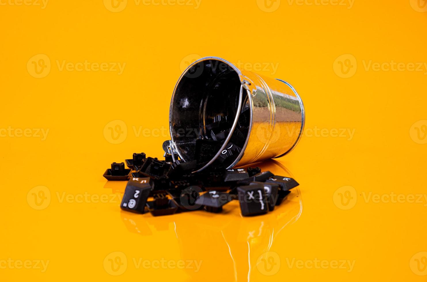 keyboard button in glass in jar in bucket on orange background photo