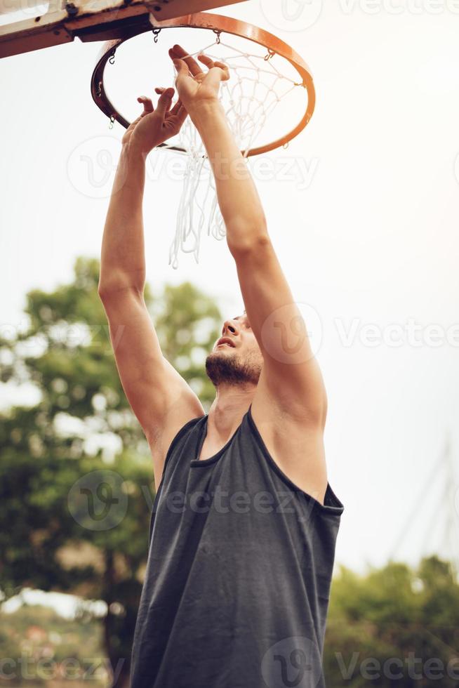 Installation Of Basketball Net On The Hoop photo