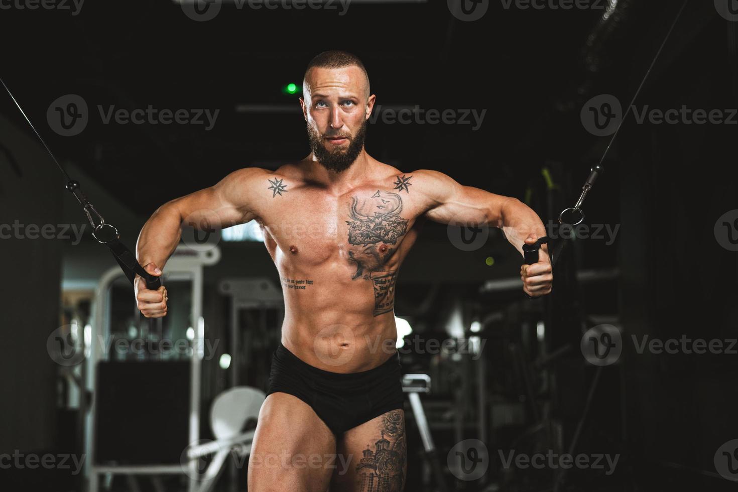 Man Doing Training On Machine For His Chest Muscle At The Gym photo