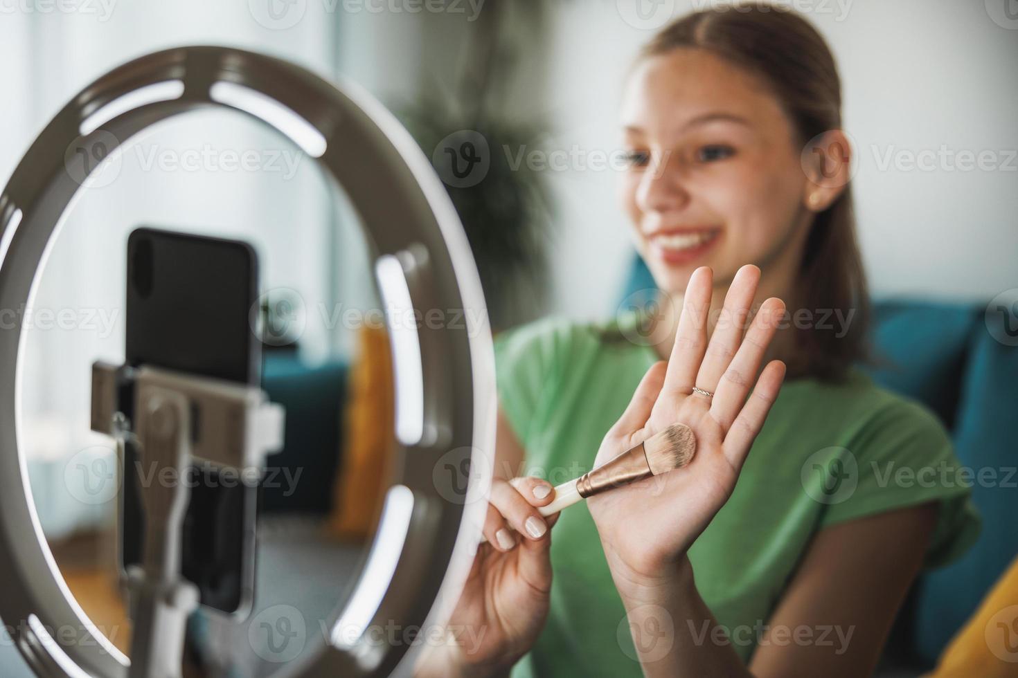 Teenager Girl Making A Video Blog On A Smartphone At Her Home photo