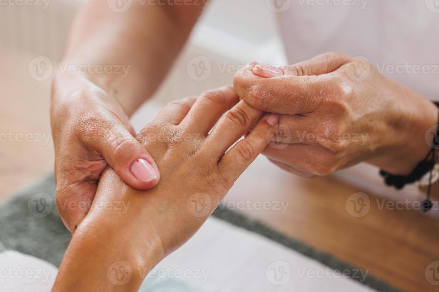 Woman Enjoying Hand Massage At Beauty Salon photo