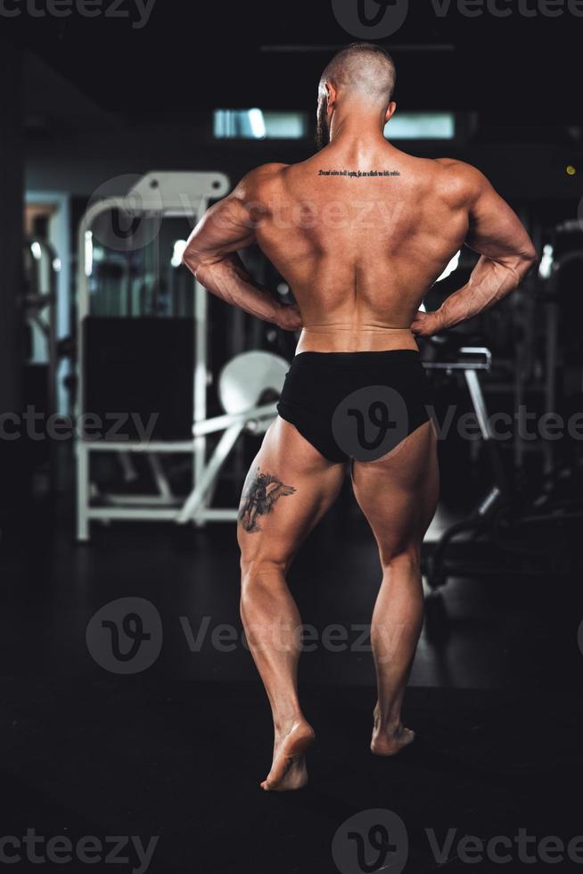 Fitness Man Showing His Muscles At The Gym photo
