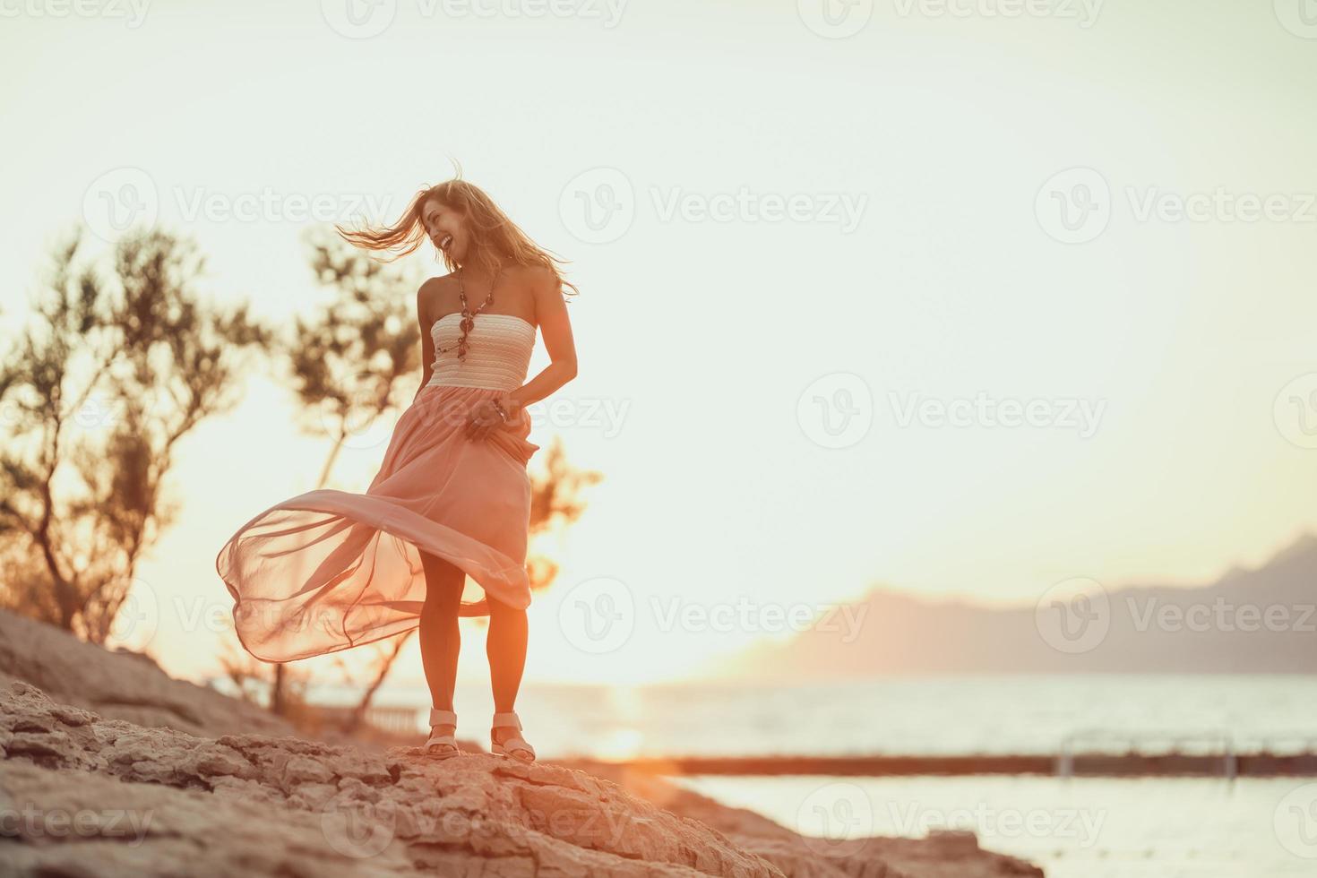 Woman Enjoying Sunset At The Beach photo