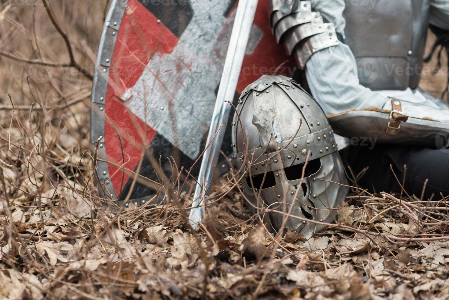 Noble warrior. Portrait of one medeival warrior or knight in armor and helmet with shield and sword posing photo