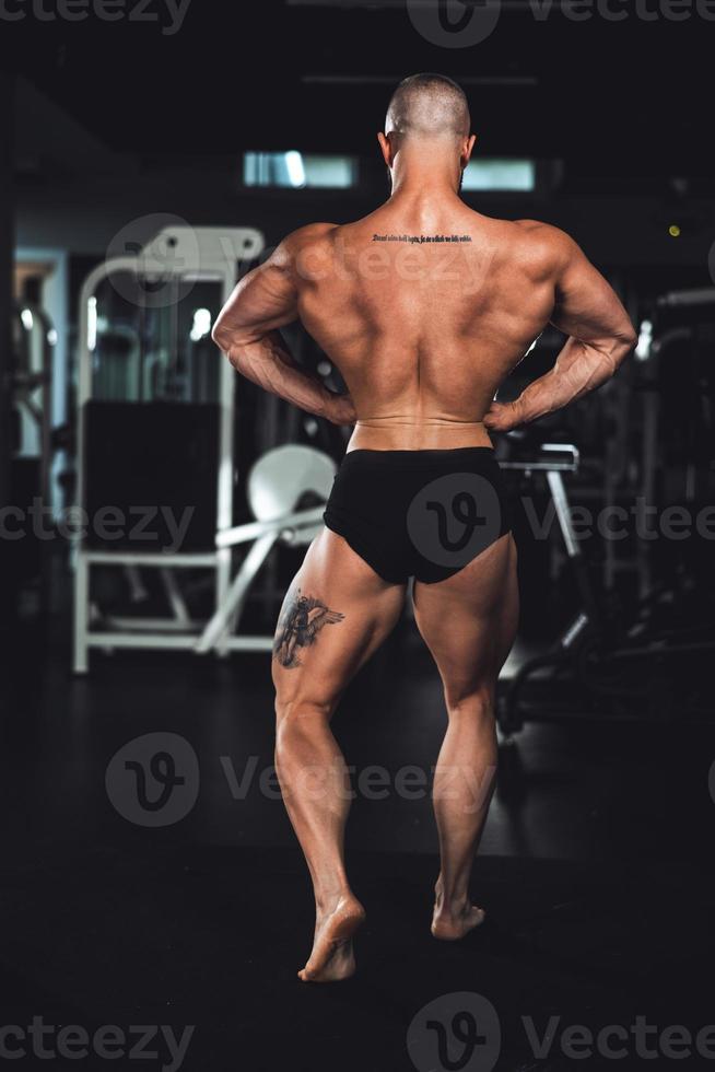 Fitness Man Showing His Muscles At The Gym photo