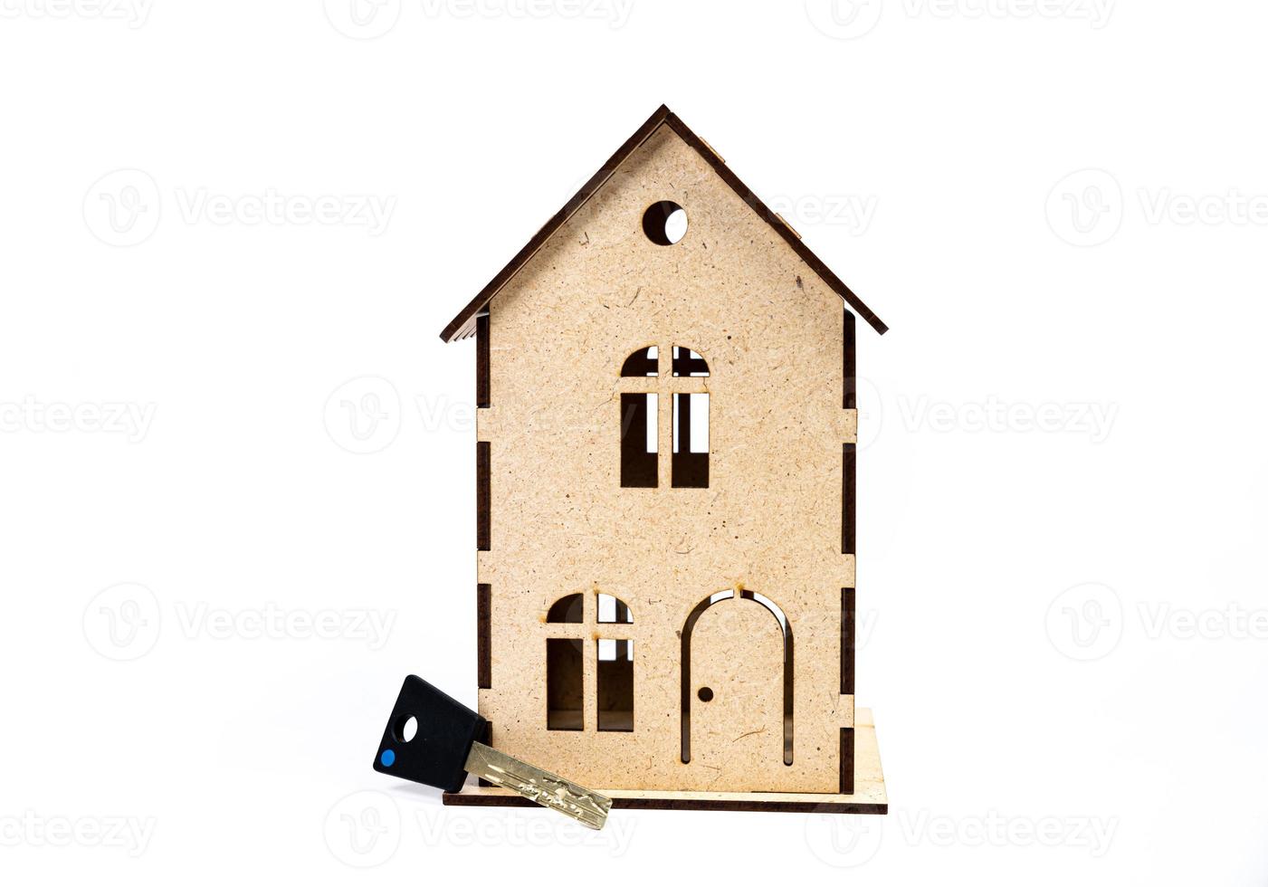 House symbol with metal key on white background. Real estate, insurance concept, mortgage, buy sell house, realtor concept photo