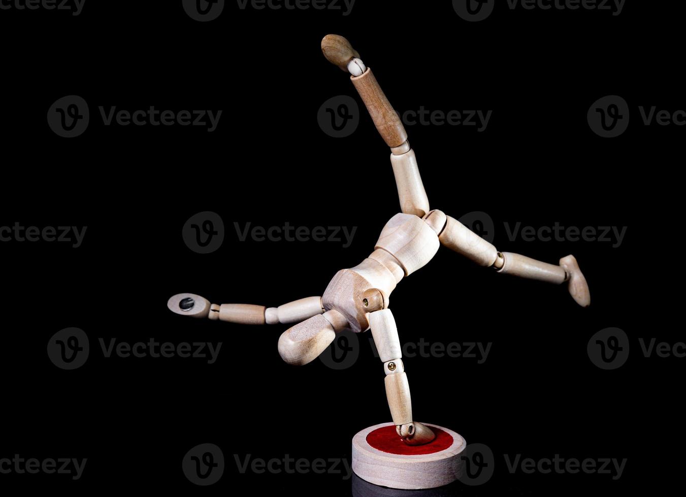 Image of wooden manikin on black background poses different posing photo