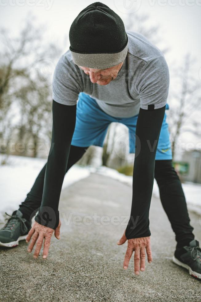 Senior Man Stretching After Jogging photo