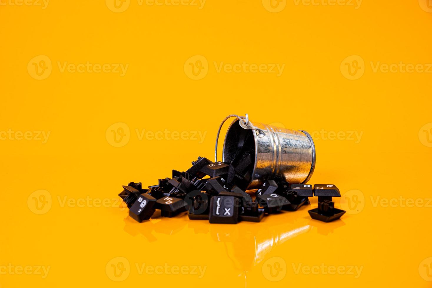 keyboard button in glass in jar in bucket on orange background photo