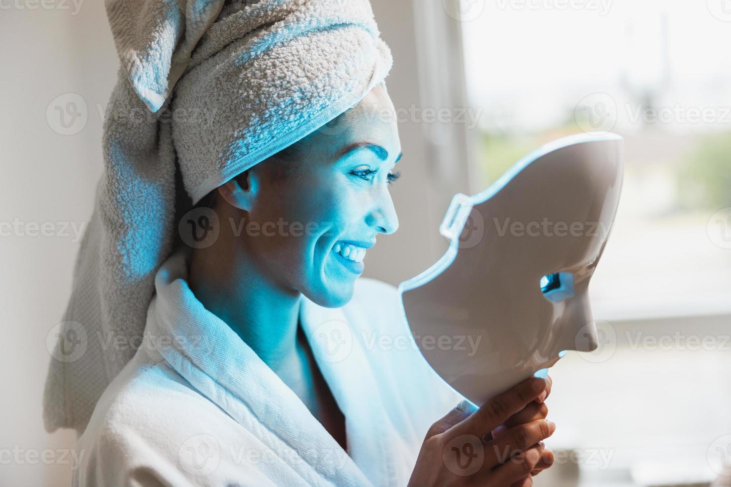 Woman Getting A Led Light Facial Mask Treatment At The Beauty Salon photo