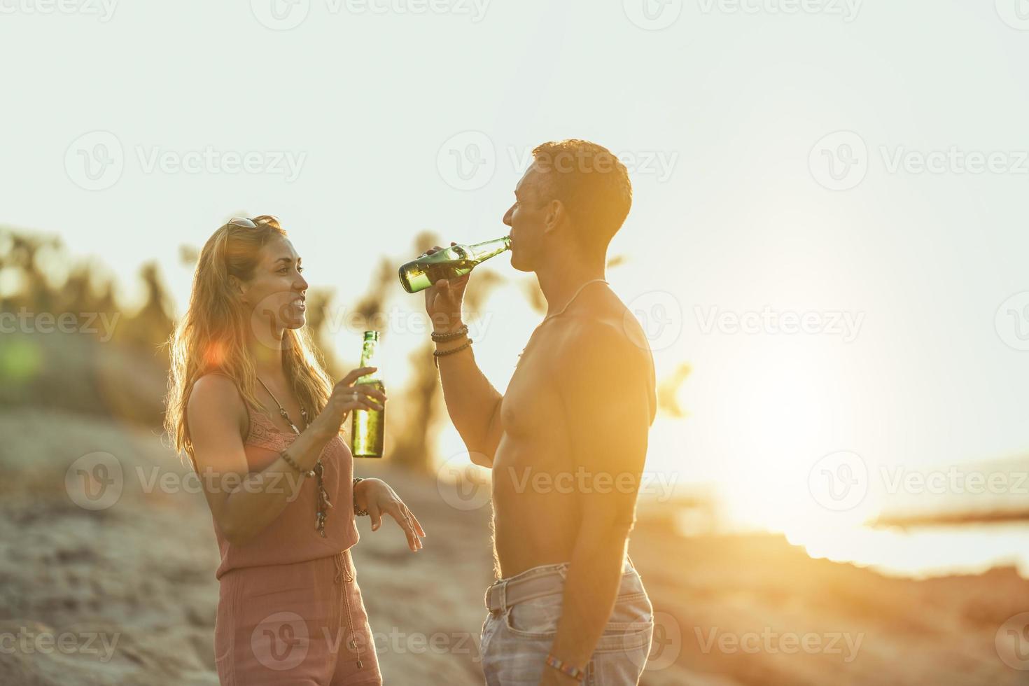 Couple Enjoying Sunset At The Beach photo
