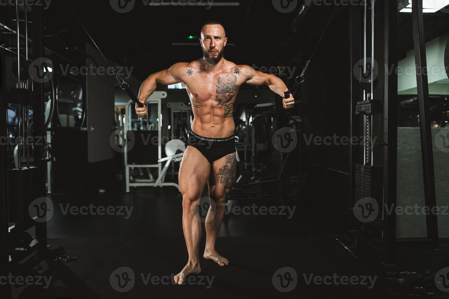 Man Doing Training On Machine For His Chest Muscle At The Gym photo