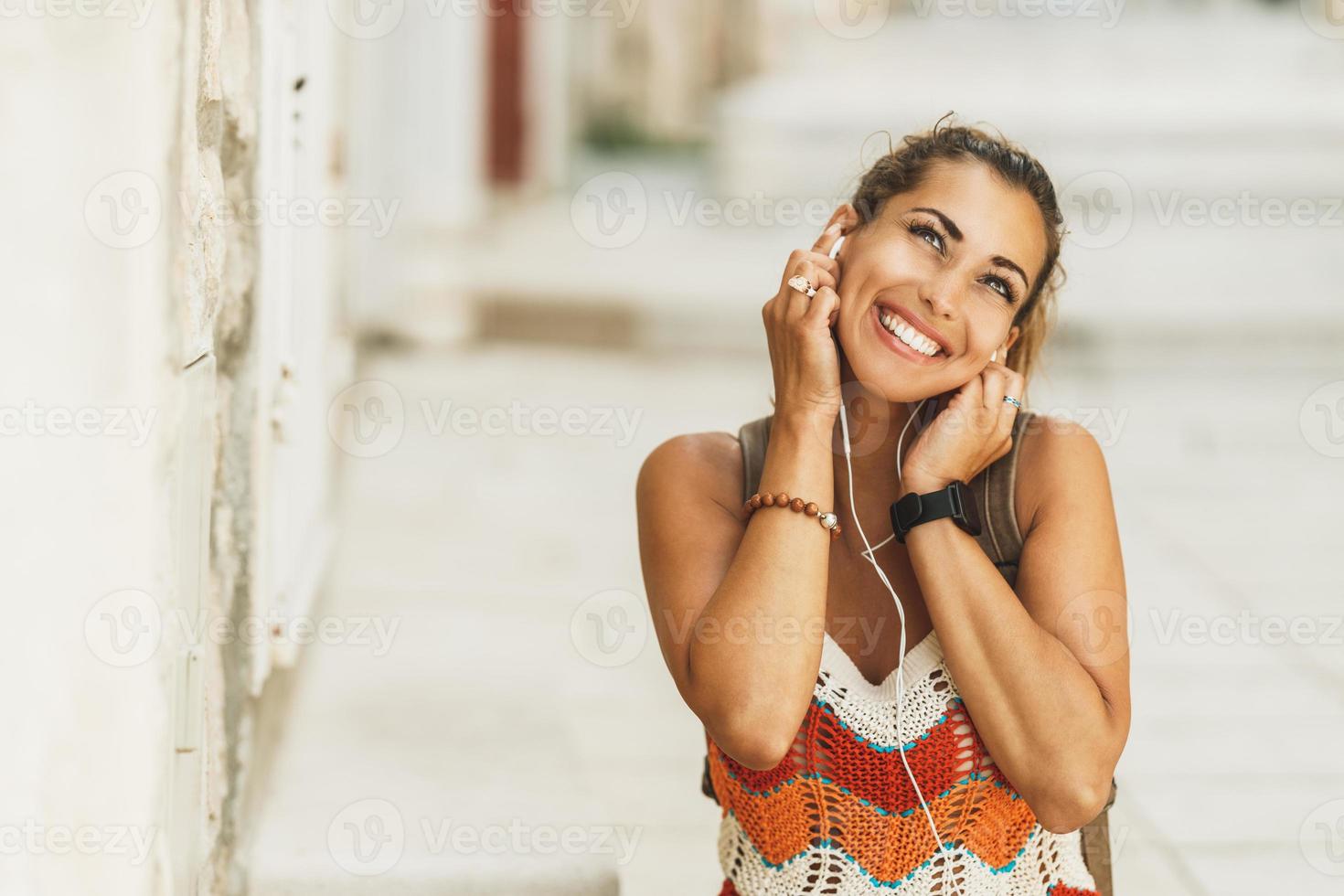 Woman Enjoying Music On A Summer Vacation In Mediterranean City photo