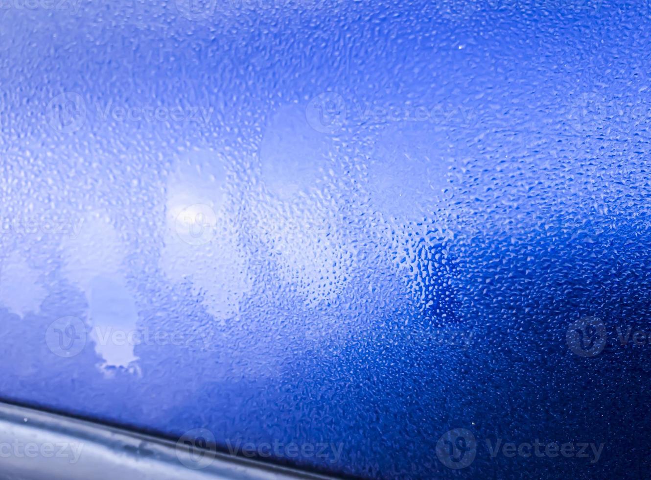 Ice crust on a blue car photo