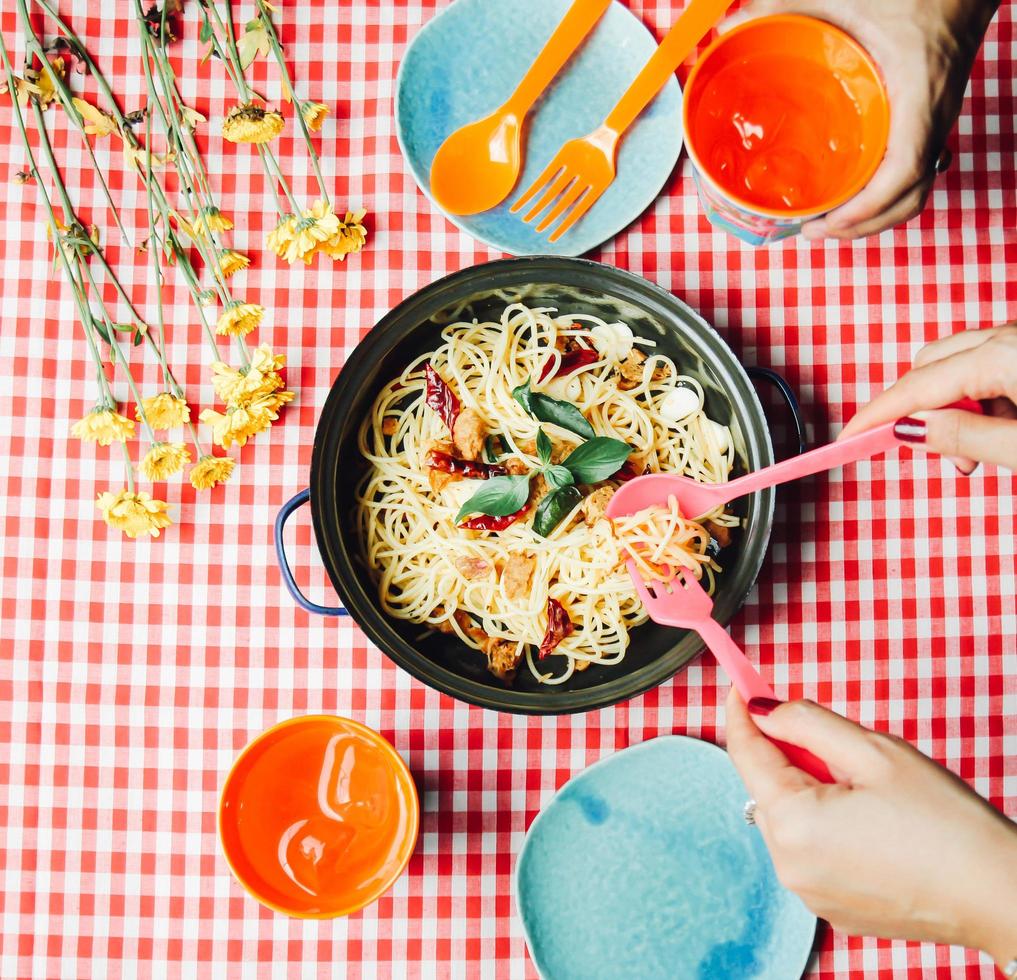 Eating homemade spaghetti with friend photo