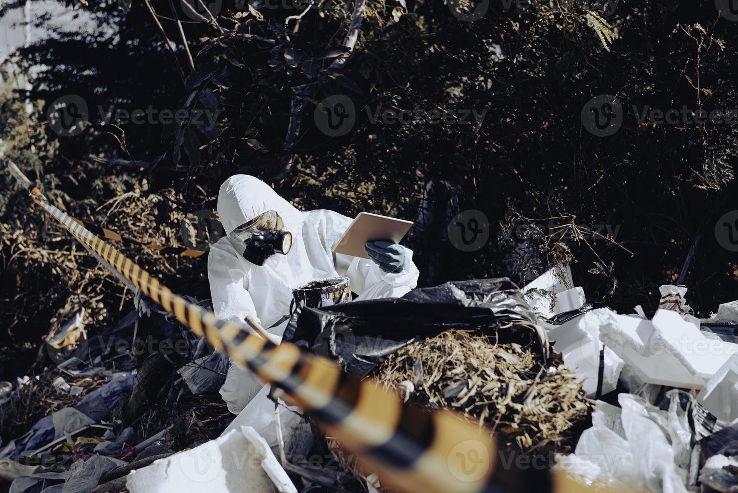 Asian scientist wear Chemical protection suit check danger chemical,working at dangerous zone photo