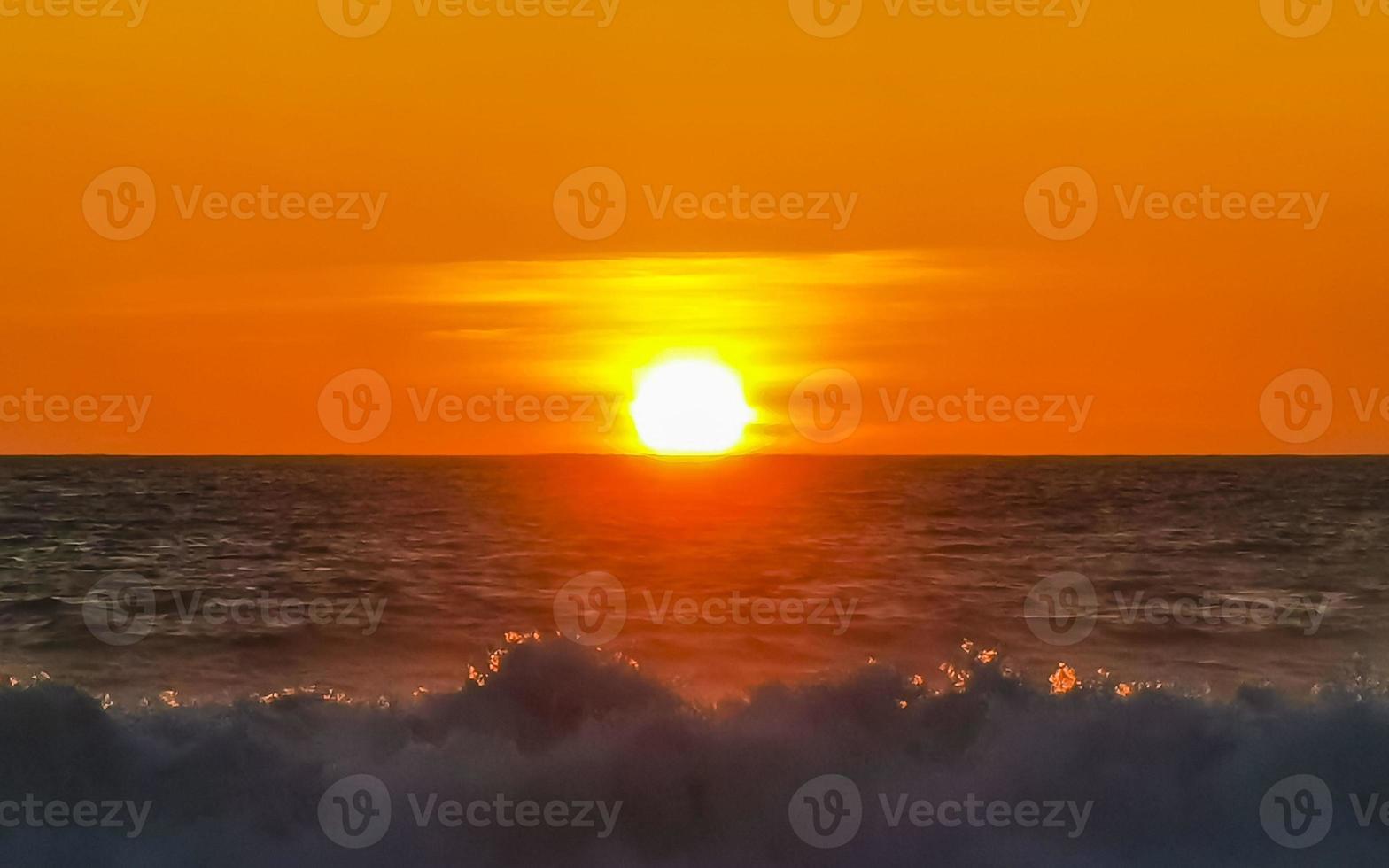 Colorful golden sunset big wave and beach Puerto Escondido Mexico. photo