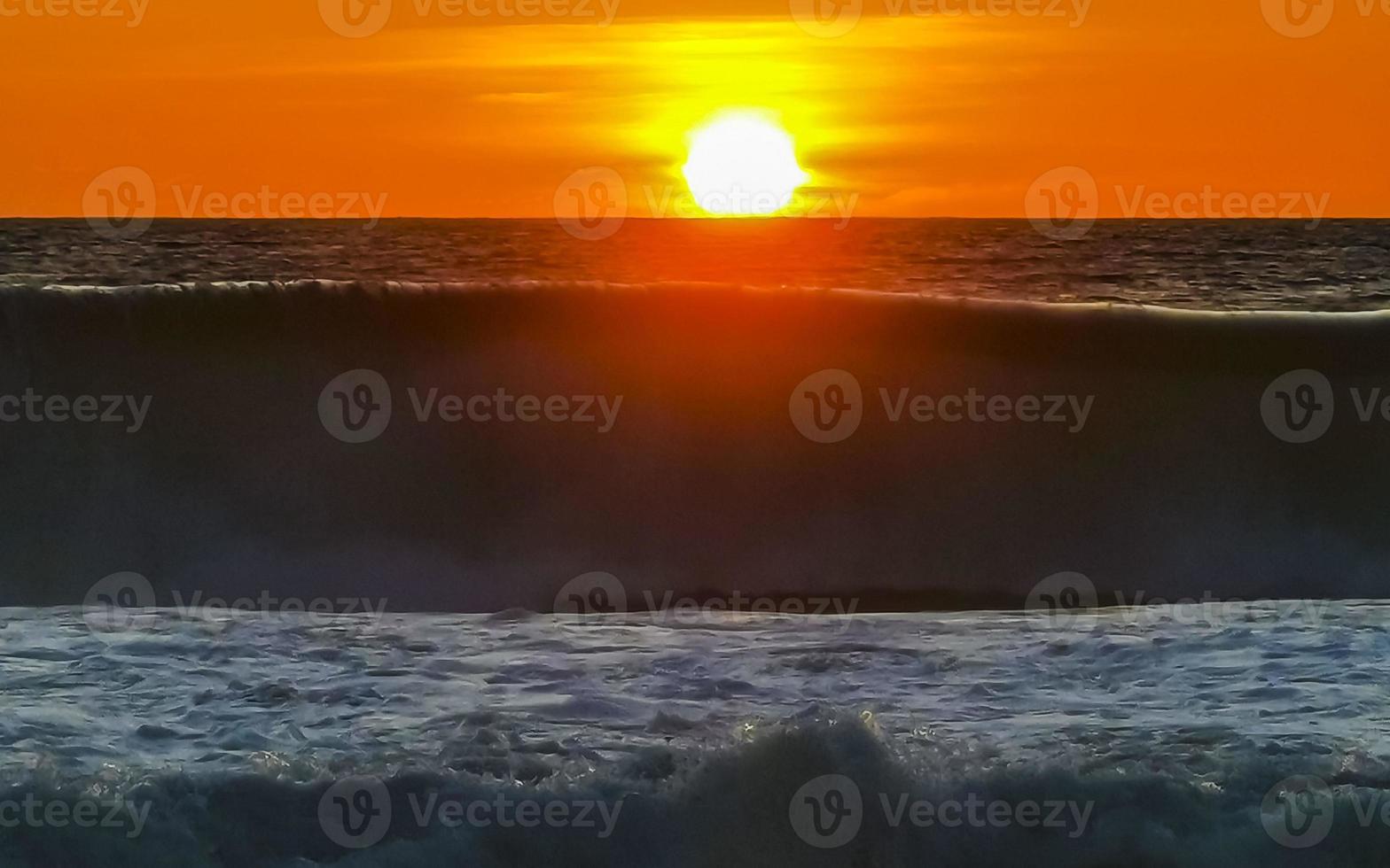 Colorful golden sunset big wave and beach Puerto Escondido Mexico. photo